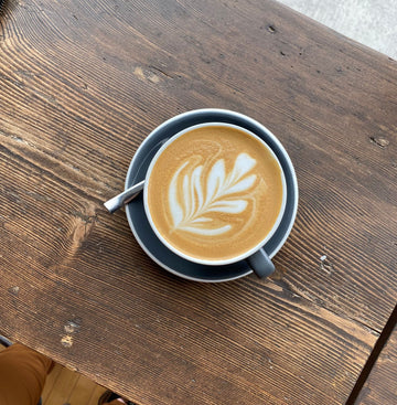 Maple syrup latte with flower latte art on it.