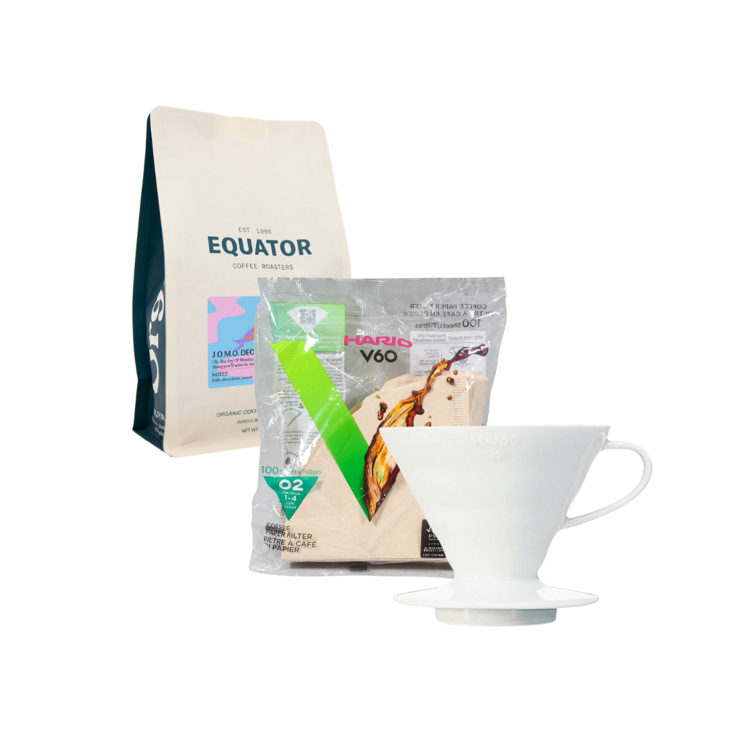 A bag of decaf coffee with a Hario V60 and filters.