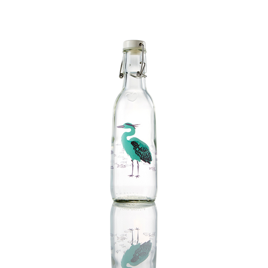 Glass bottle with a heron design on it.