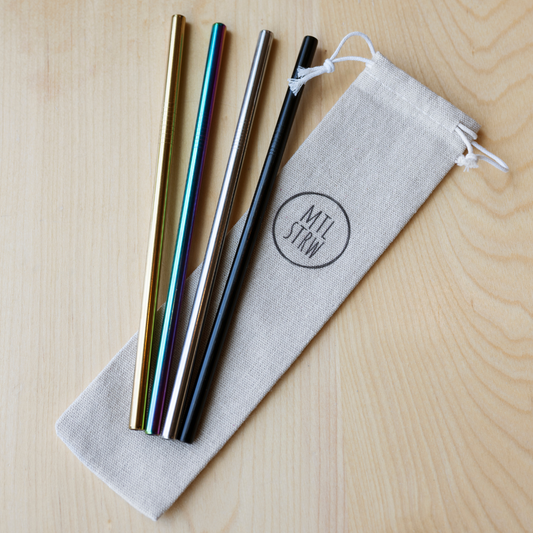 Set of metal straws with a carrying pouch on a wooden surface