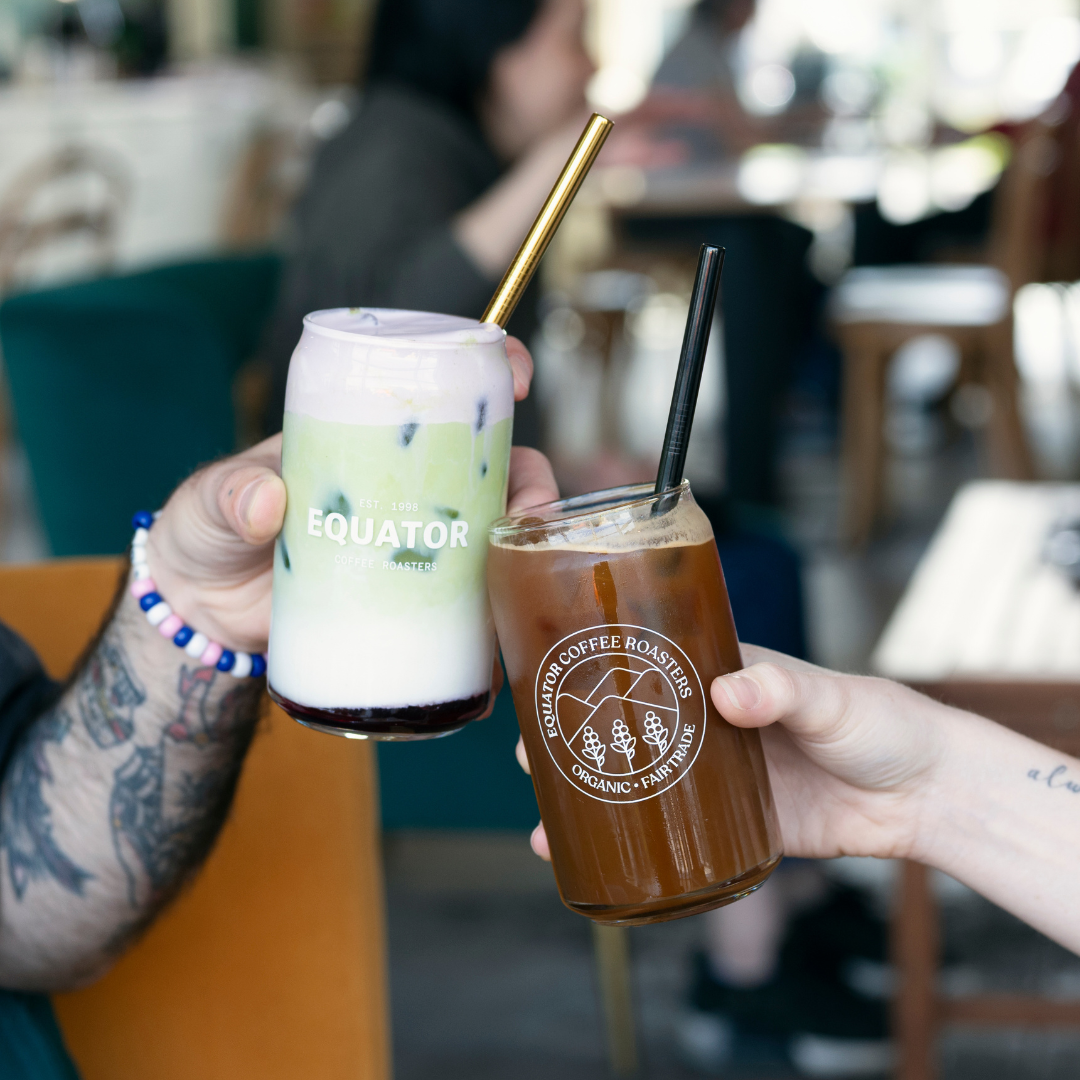 Two drinks in Equator branded glasses with reusable straws.