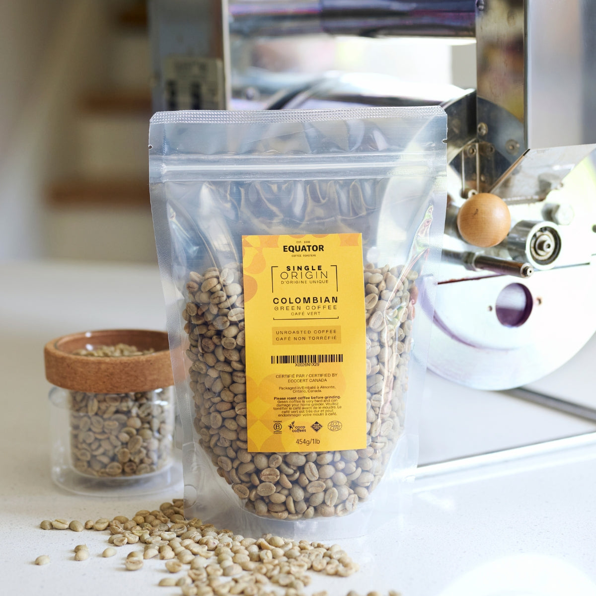 Resealable package of unroasted beans from Colombia with a home roaster in the background.