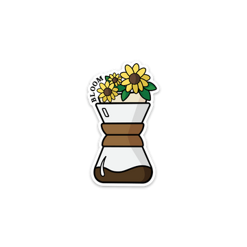Sticker of a Chemex with sunflowers out the top of it, with the word Bloom on the left side of the flowers.