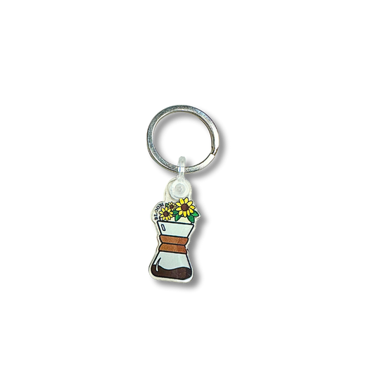 Keychain with sunflowers at the top of a Chemex.