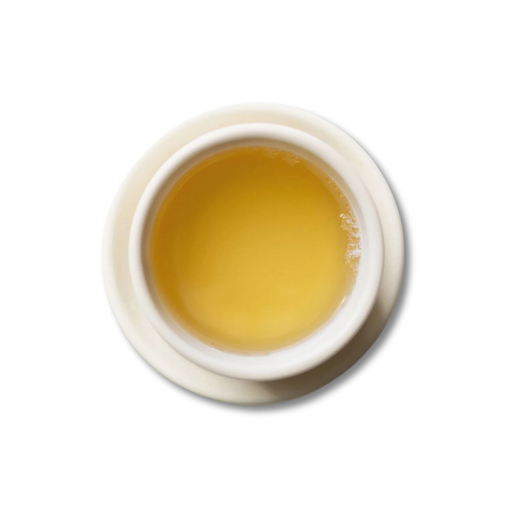 White teacup with steeped Chamomile Medley tea.