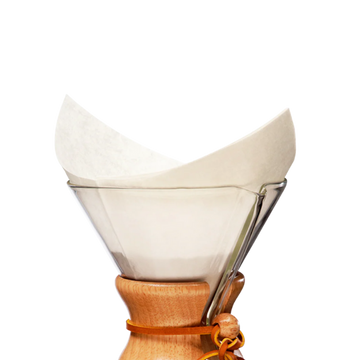 White Chemex coffee filter in the top of the brewer.