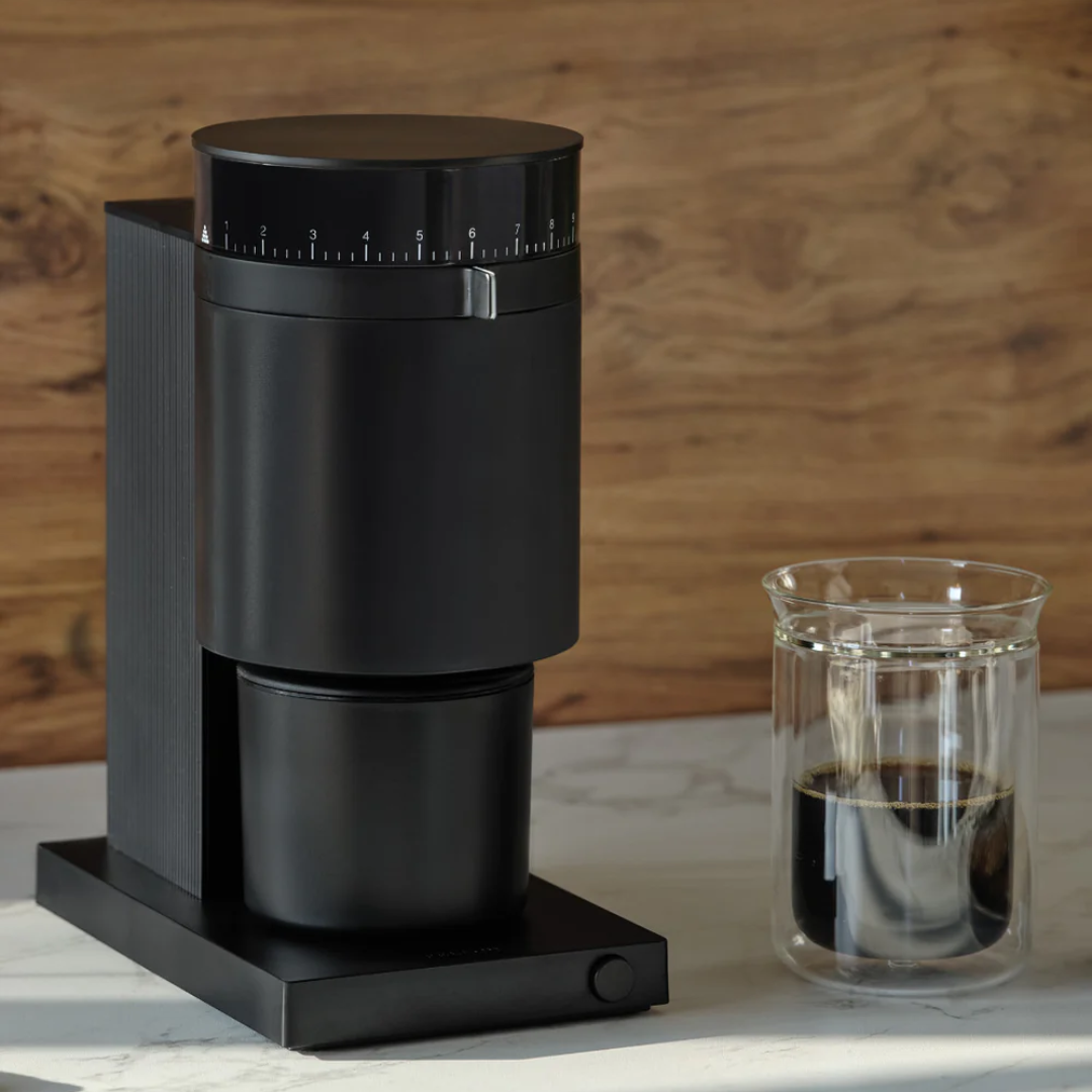 Fellow Opus Grinder with a cup of coffee beside it.