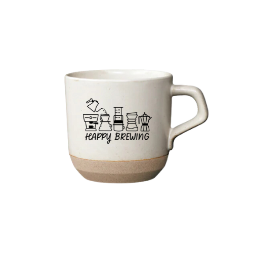 A white ceramic mug with 'Happy Brewing' text and coffee-related illustrations such as a cup, saucer, and scale.