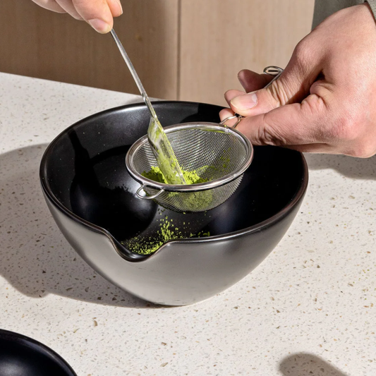 Person using a Matcha Sifter into a Rishi Matcha Pouring Bowl