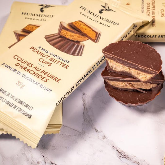 Packages of peanut butter cups with three stacked to show what they look like.
