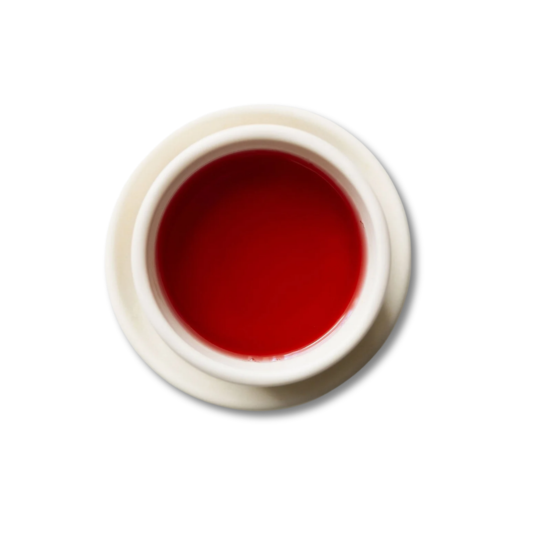 White teacup with Scarlet steeped tea.