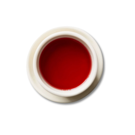 White teacup with Scarlet steeped tea.
