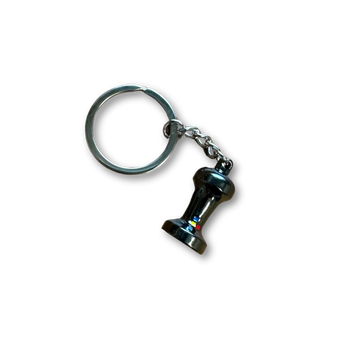 A silver medal keychain with a small replica espresso tamper.