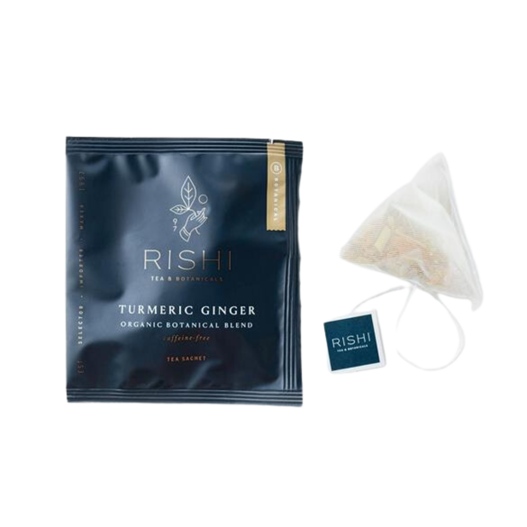 Package of Rishi organic turmeric ginger tea and tea bag.