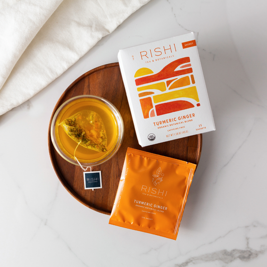 Rishi Turmeric Ginger tea packaging and glass of steeped tea