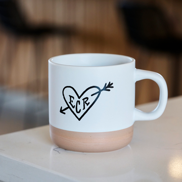Ceramic mug with a heart and arrow with ECR (Equator Coffee Roasters) in the center.