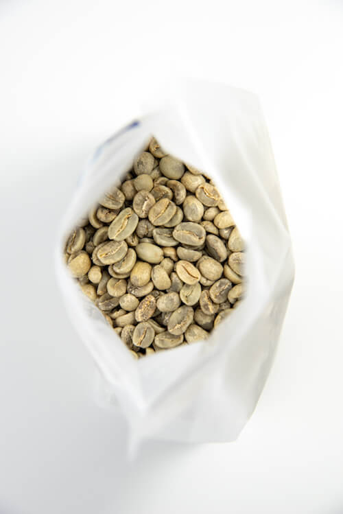 Looking into the bag of green coffee beans
