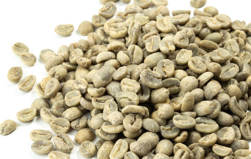 Close up of a pile of green coffee beans.